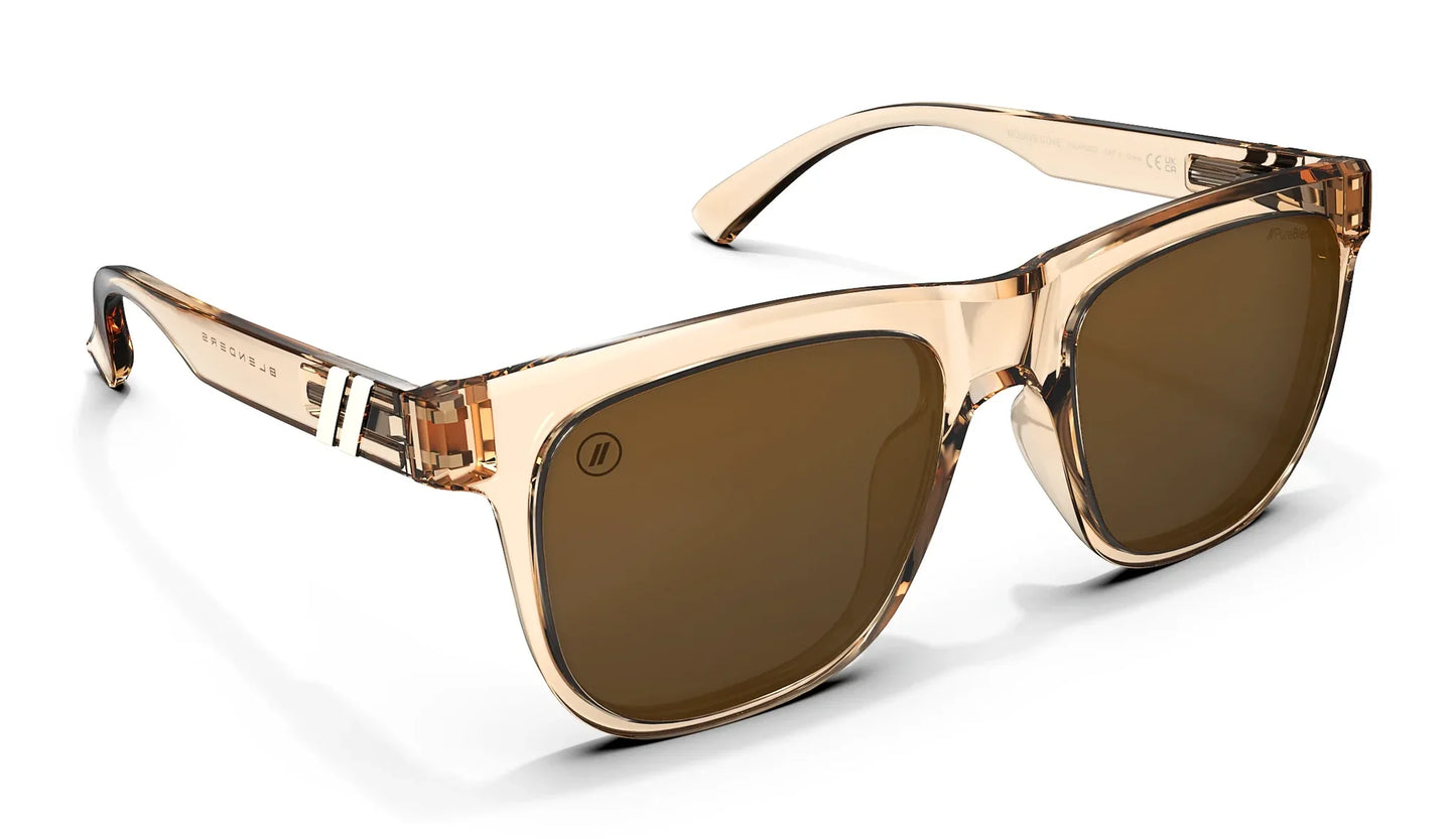 A close up, angled front view of the Mojave Cove Blenders Sunglasses showcasing the inside and outside of the crystal tan frame and PureBlend™ amber lenses of the sunglasses.
