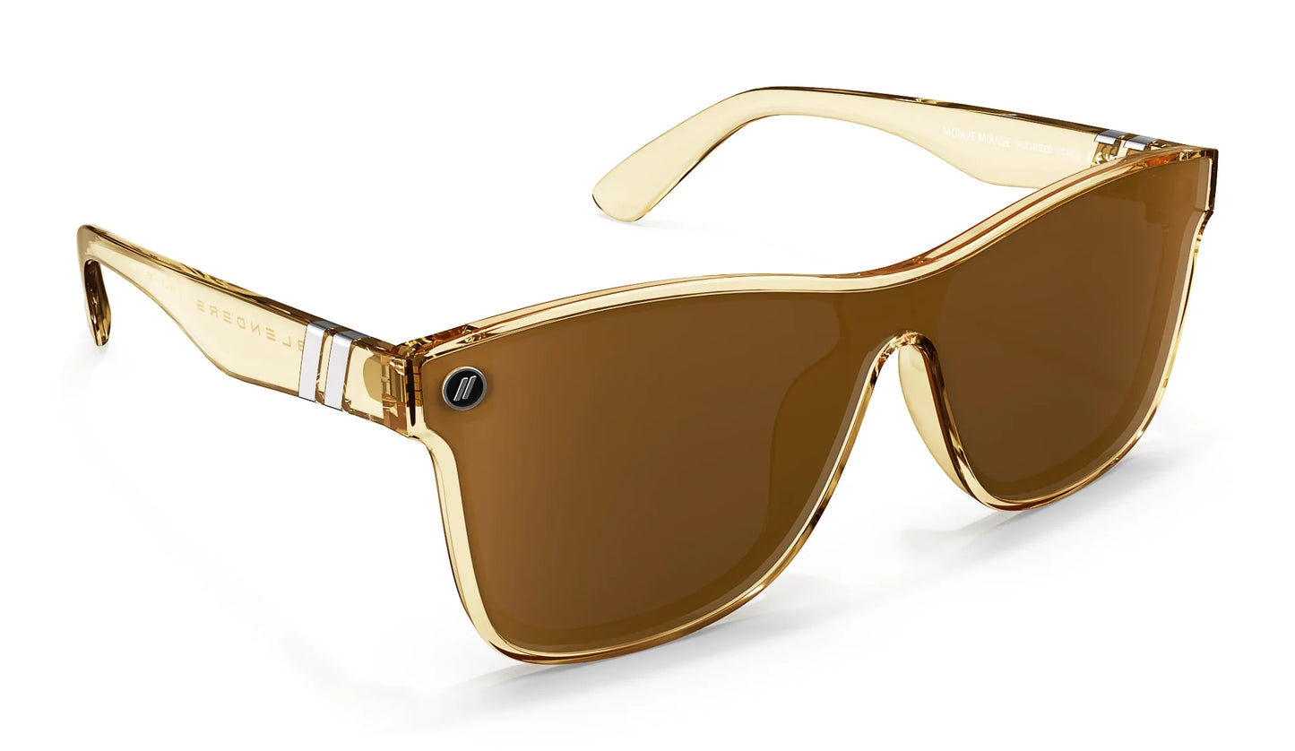 A close up, angled front view of the Mojave Mirage Blenders Sunglasses showcasing the inside and outside of the gloss crystal tan frames and polarized amber lenses of the sunglasses.