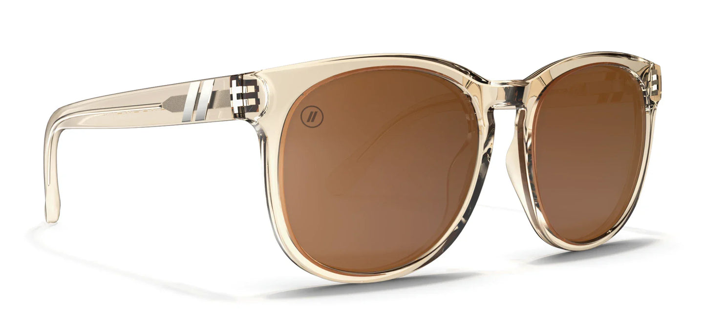 A close up, angled view of the front and right side of the Mojave Moon Blenders Sunglasses showcasing the crystal tan frame and PureBlend™ amber lenses of the sunglasses.