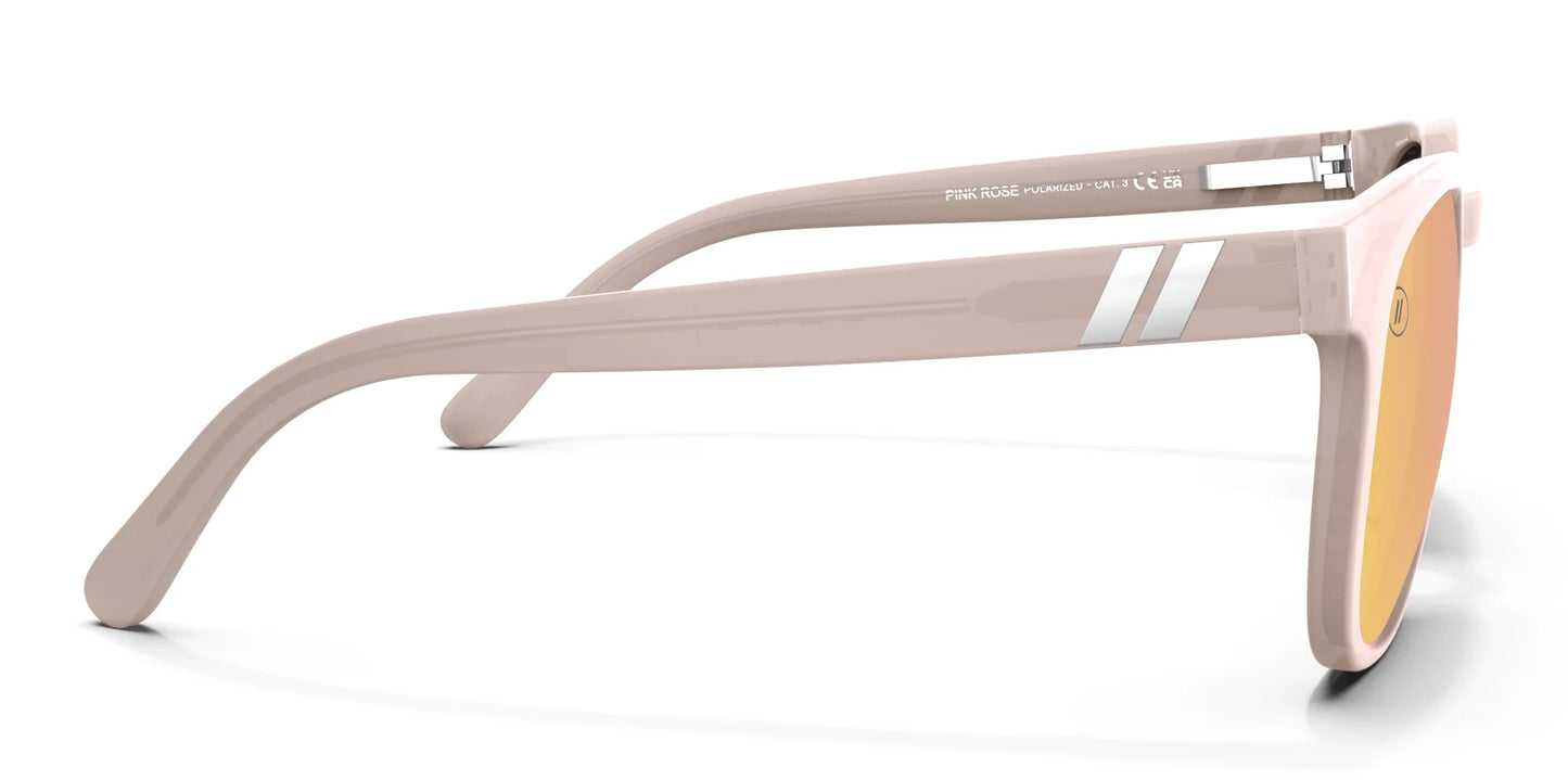 A close up, right side view of the Pink Rose Blenders Sunglasses showcasing the inside and outside of the glossed milky pink frame and polarized PureBlend™ pink mirrored lenses of the sunglasses.