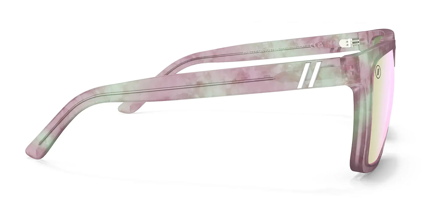 A close up, right side view of the Pretty Gangsta' Blenders Sunglasses showcasing the inside and outside of the gloss crystal clear gray and pink tortoise frame and polarized pink mirrored lenses of the sunglasses.