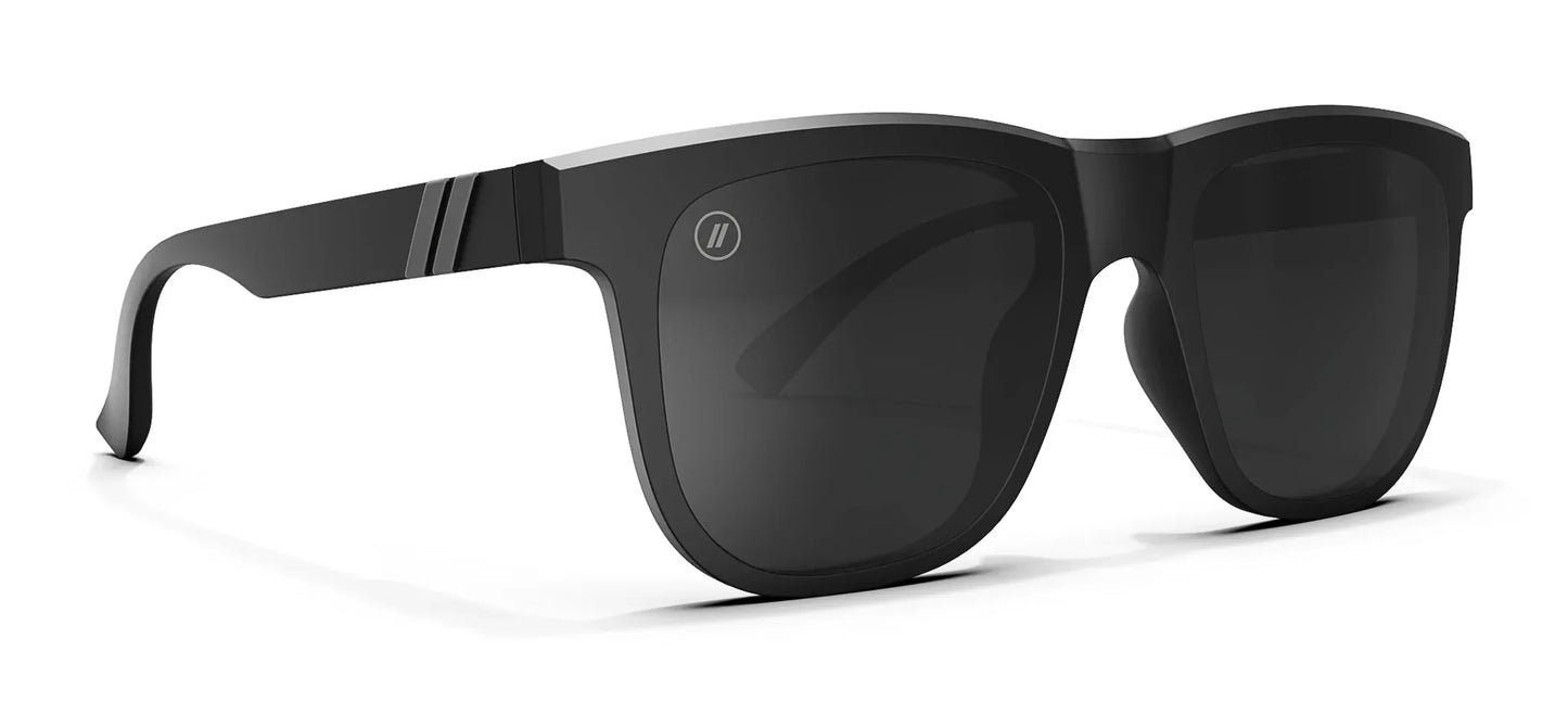A close up, angled view of the front and right side of the Shadow Cruise Blenders Sunglasses showcasing the glossy black frame and PureBlend™ smoke black lenses of the sunglasses.