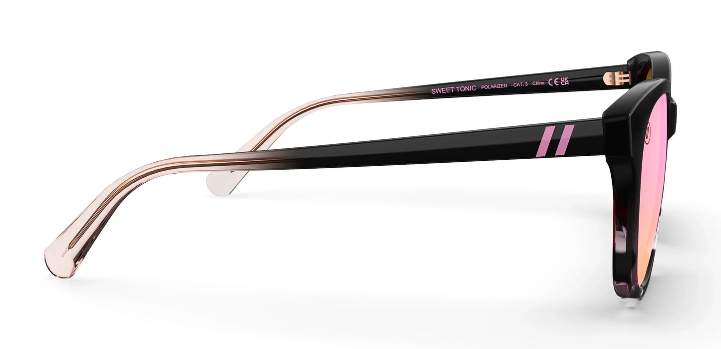 A close up, angled view of the front and right side of the Sweet Tonic Blenders Sunglasses showcasing the inside and outside of the glossy black and pink tortoise frame and polarized pink mirrored lenses of the sunglasses.