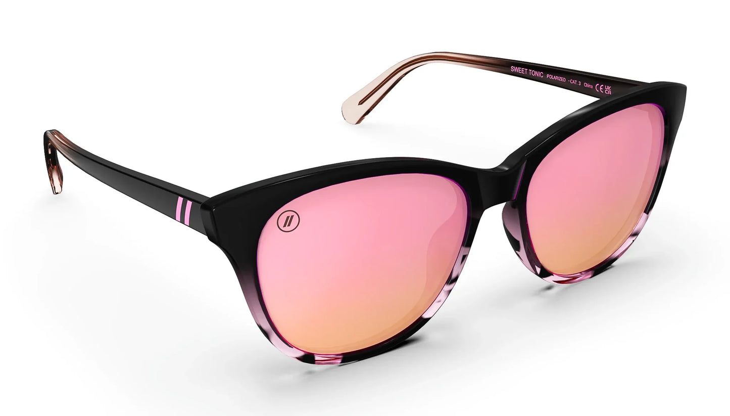 A close up, angled front view of the Sweet Tonic Blenders Sunglasses showcasing the inside and outside of the glossy black and pink tortoise frame and polarized pink mirrored lenses of the sunglasses.