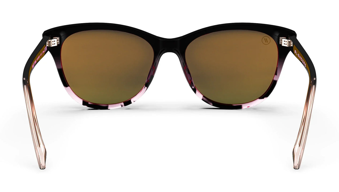 A close up, back view of the Sweet Tonic Blenders Sunglasses showcasing the inner sides of the glossy black and pink tortoise frame and polarized pink mirrored lenses of the sunglasses.