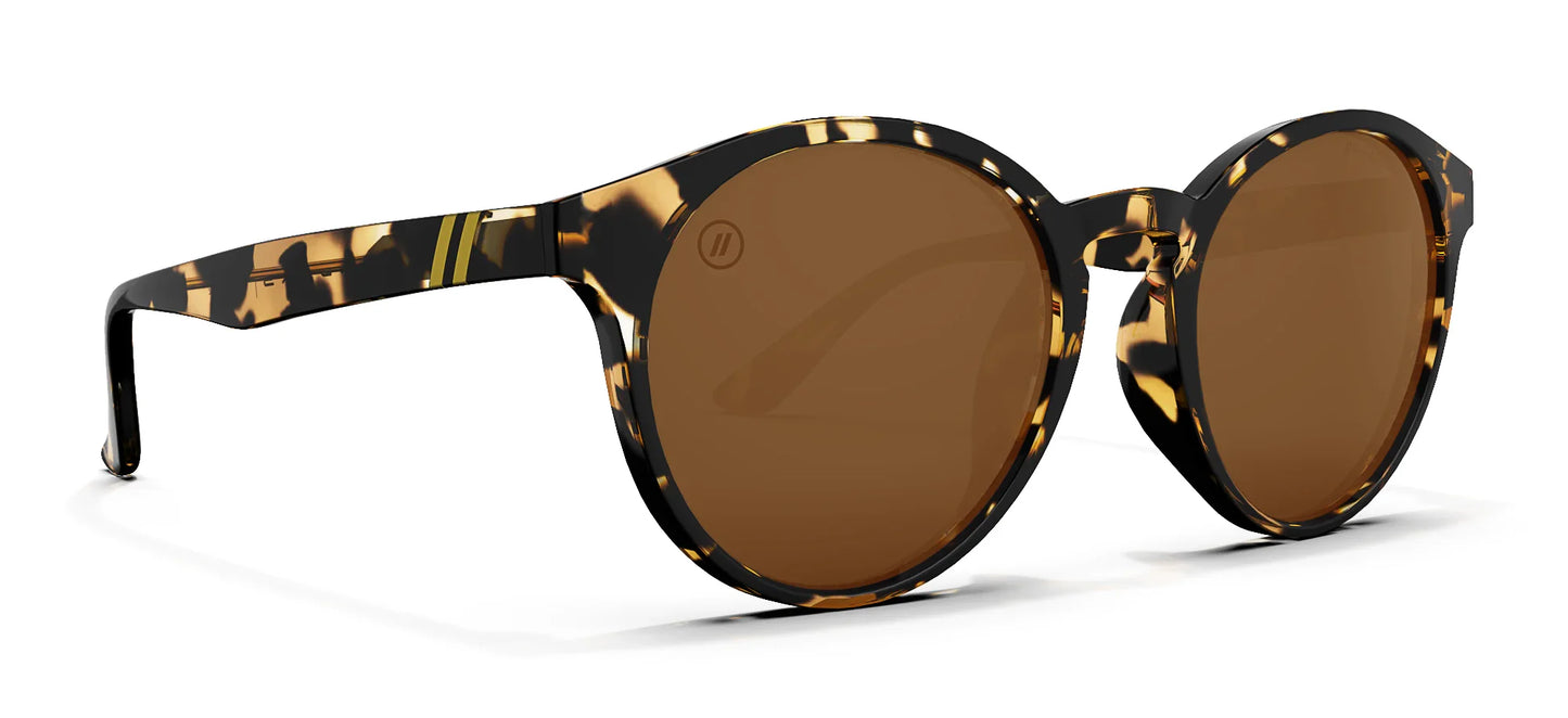 A close up, angled view of the front and right side of the Tort Blenders Sunglasses showcasing the gloss tan tortoise frame and polarized PureBlend™ amber lenses of the sunglasses.