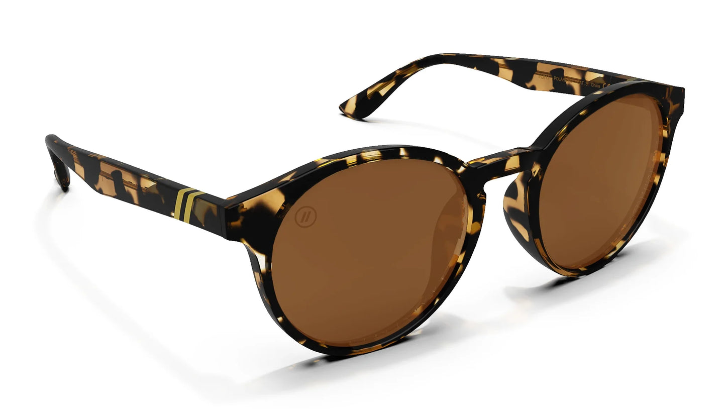 A close up, angled front view of the Tort Blenders Sunglasses showcasing the inside and outside of the gloss tan tortoise frame and polarized PureBlend™ amber lenses of the sunglasses.