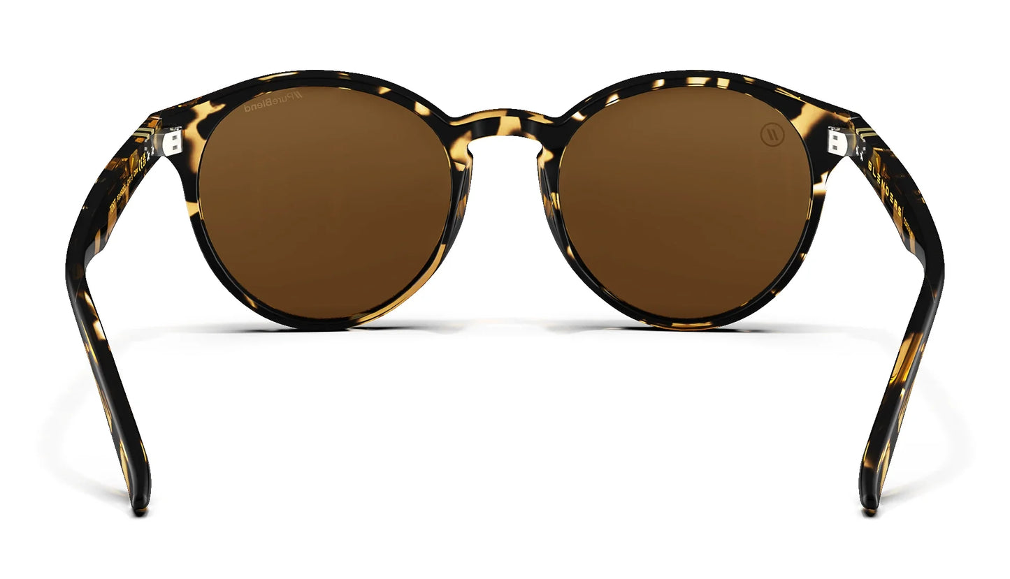 A close up, back view of the Tort Blenders Sunglasses showcasing the inner sides of the gloss tan tortoise frame and polarized PureBlend™ amber lenses of the sunglasses.