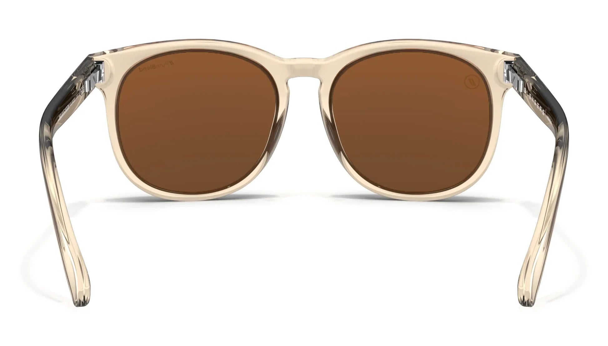 A close up, back view of the Mojave Moon Blenders Sunglasses showcasing the inner sides of the crystal tan frame and PureBlend™ amber lenses of the sunglasses.