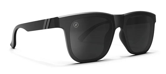A close up, angled view of the front and right side of the Shadow Cruise Blenders Sunglasses showcasing the glossy black frame and PureBlend™ smoke black lenses of the sunglasses.