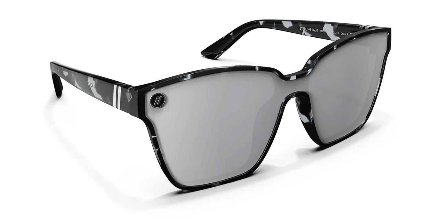 A close up, angled front view of the Sterling Lady Blenders Sunglasses showcasing the inside and outside of the crystal gray and solid black tortoise pattern frames and polarized silver mirrored lenses of the sunglasses.